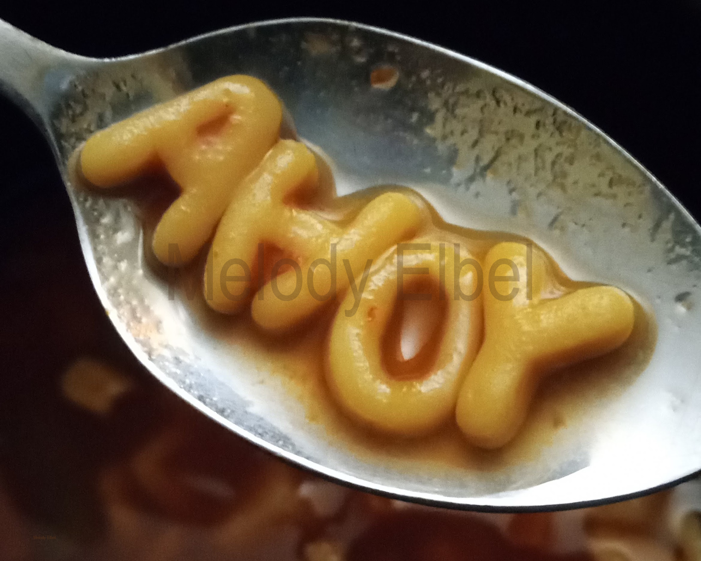 A photo of alphabet soup that says ahoy